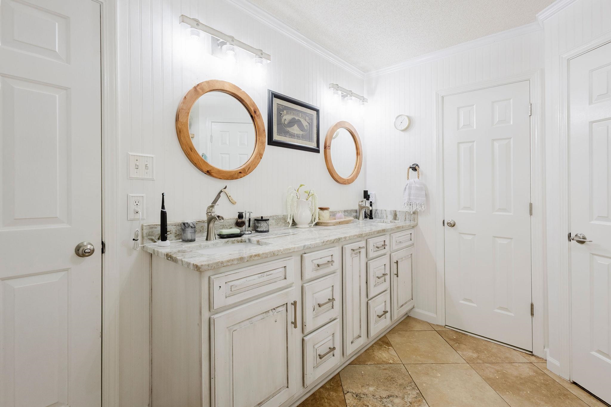 305 Great Falls Road Collierville, TN 38017 - Photo 11 of 23 Double vanity featuring light-toned cabinetry, a light stone-finish countertop, and two vessel sinks