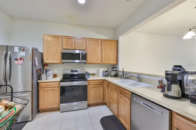 a kitchen with a sink stove and refrigerator