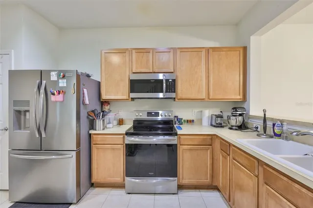 a kitchen with a sink stove and refrigerator