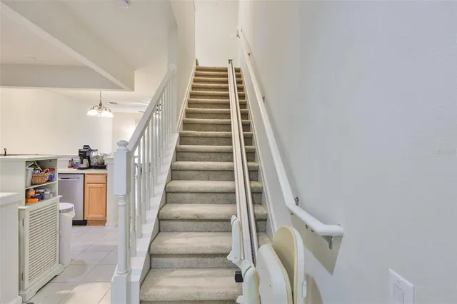 a view of staircase with white walls and stairs
