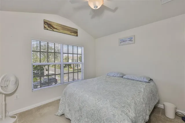 a bed sitting in a bedroom next to a window