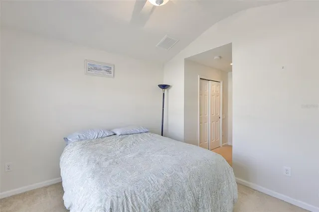 a bed sitting in a bedroom and closet