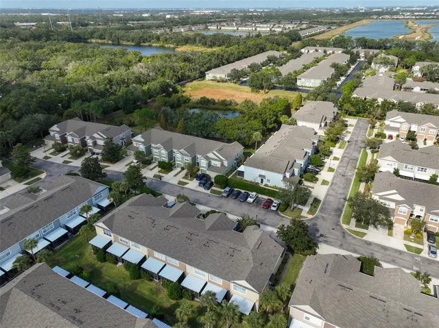 a view of a house with a garden and lake view