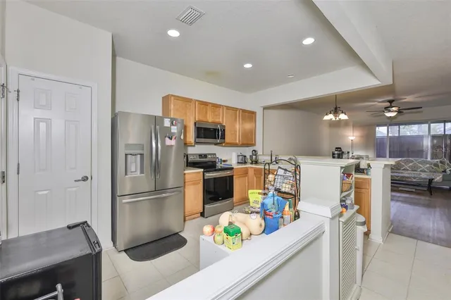 a kitchen with stainless steel appliances granite countertop a refrigerator sink and stove