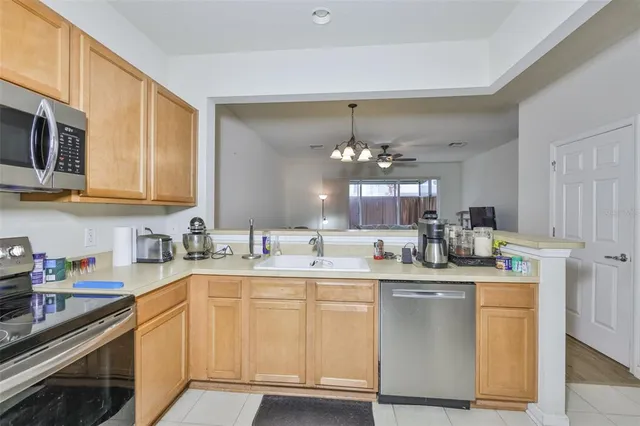 a kitchen with stainless steel appliances a sink stove and cabinets