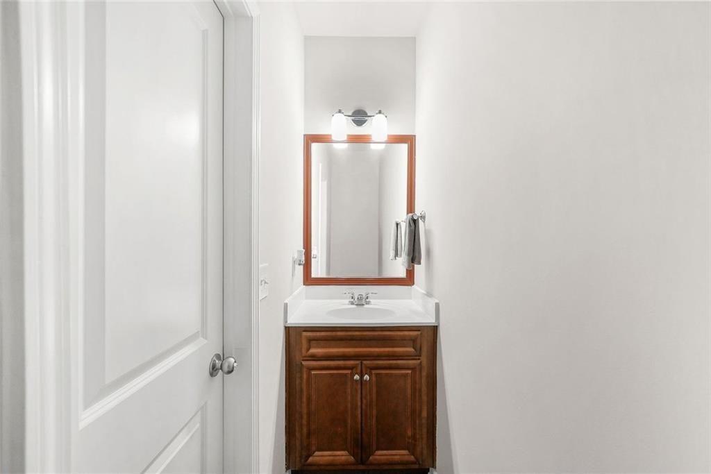 7823 Shertall Road Fairburn, GA 30213 - Photo 14 of 40 a bathroom with a sink and a mirror