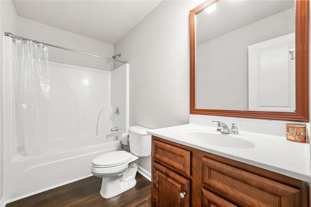7823 Shertall Road Fairburn, GA 30213 - Photo 17 of 40 a bathroom with a sink toilet a shower and a mirror