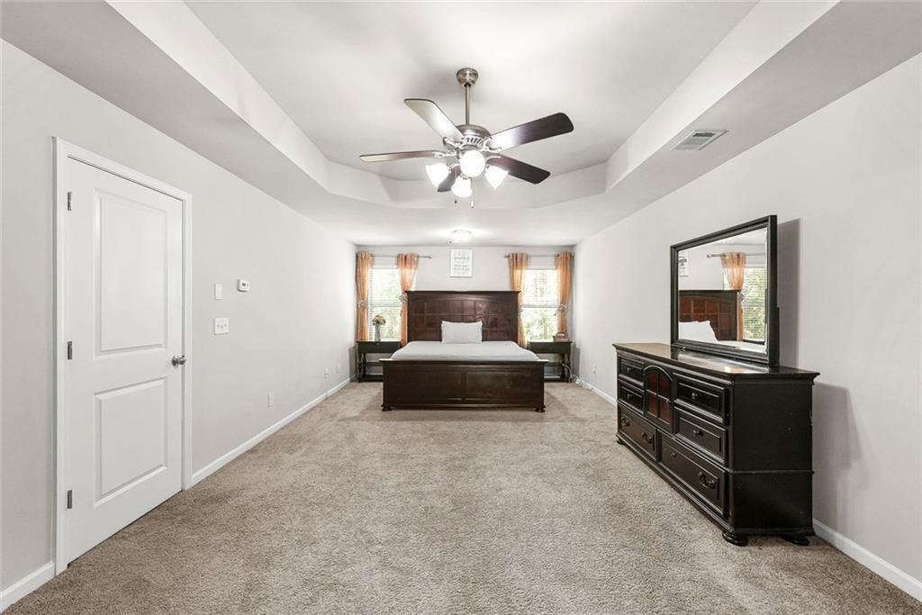 7823 Shertall Road Fairburn, GA 30213 - Photo 20 of 40 a living room with furniture and a flat screen tv