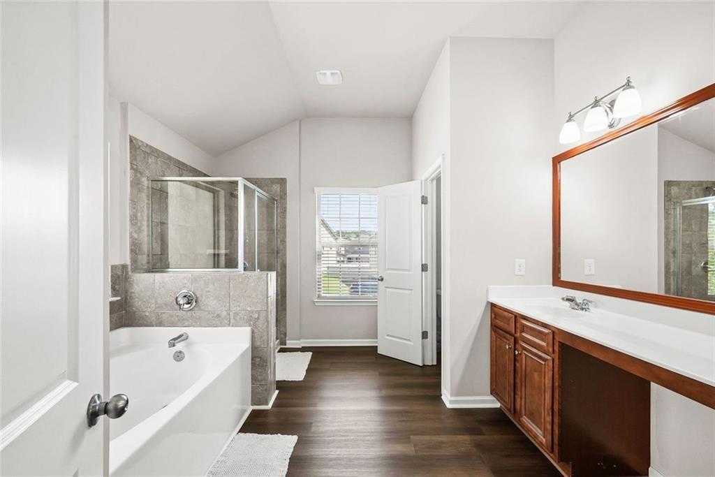 7823 Shertall Road Fairburn, GA 30213 - Photo 23 of 40 a bathroom with a bathtub shower and a sink