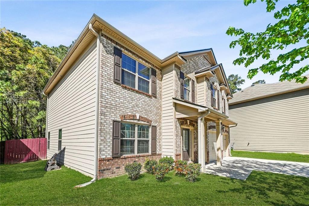 7823 Shertall Road Fairburn, GA 30213 - Photo 32 of 40 a front view of a house with a garden