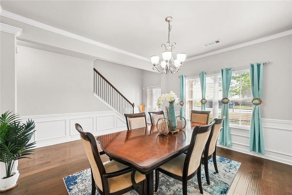 7823 Shertall Road Fairburn, GA 30213 - Photo 4 of 40 a view of a dining room with furniture and wooden floor