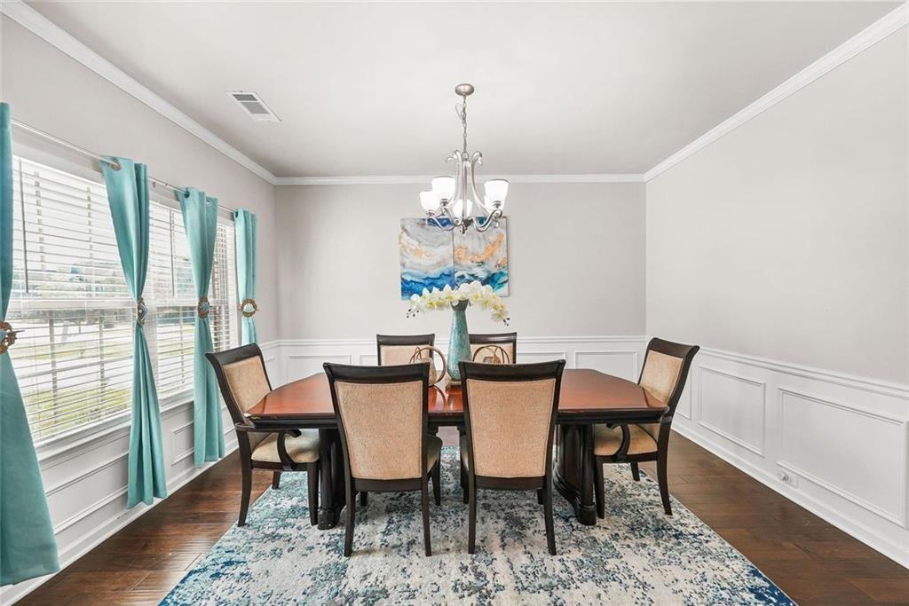 7823 Shertall Road Fairburn, GA 30213 - Photo 5 of 40 a view of a dining room with furniture window and wooden floor