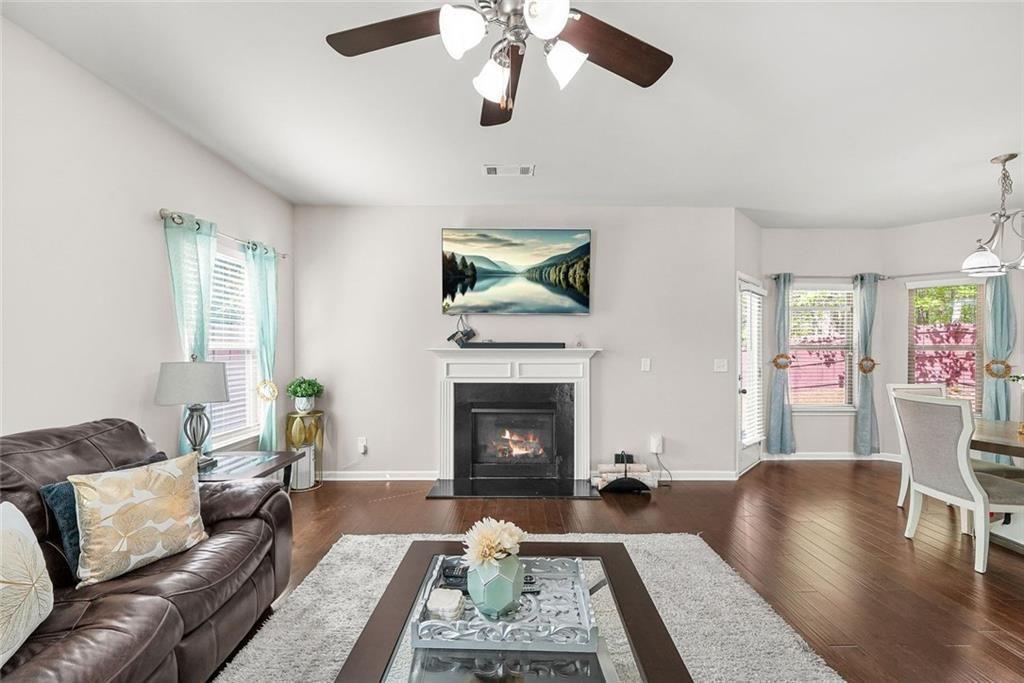 7823 Shertall Road Fairburn, GA 30213 - Photo 8 of 40 a living room with furniture and a fireplace