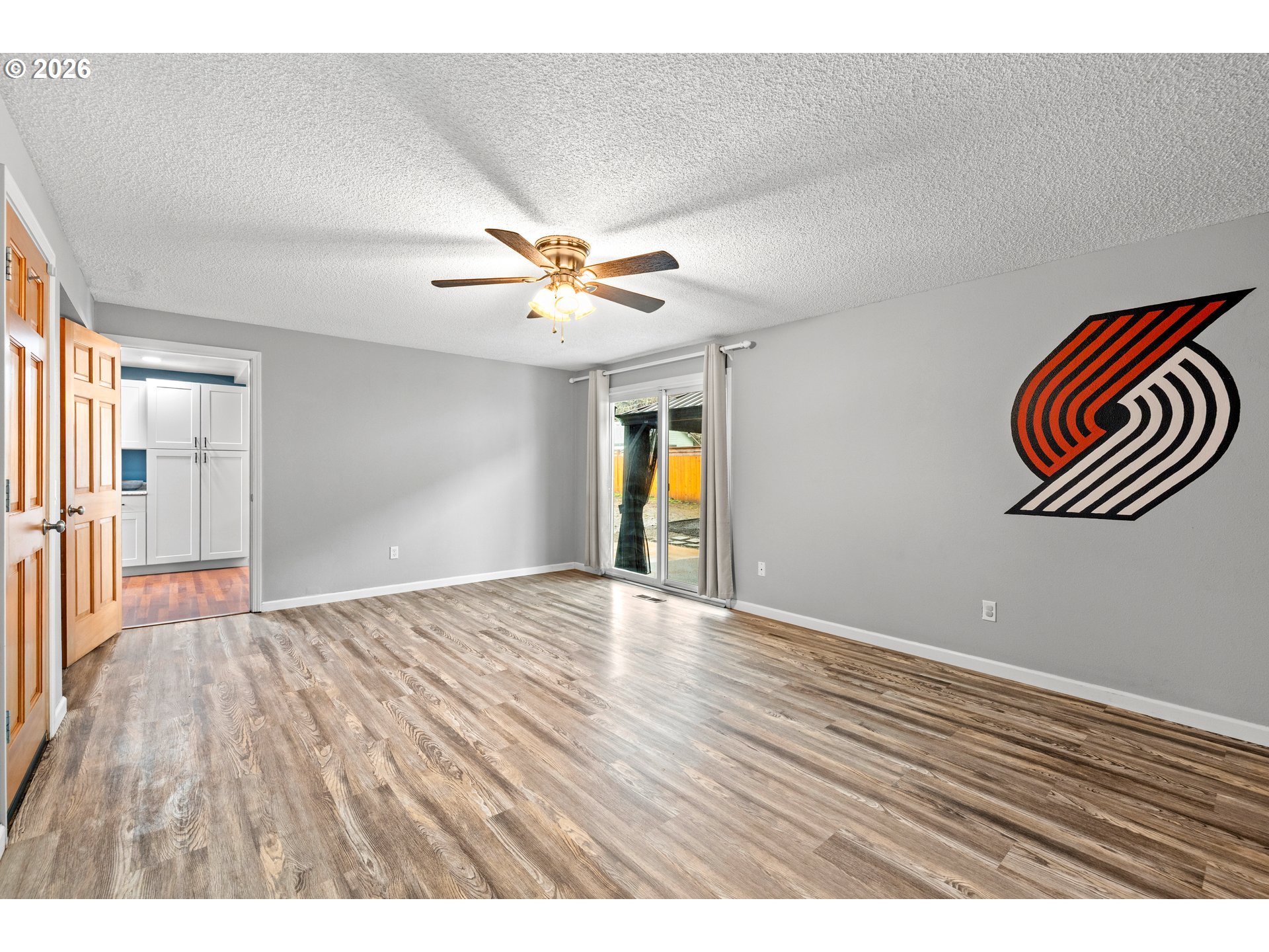493 South Emerald Loop Cornelius, OR 97113 - Photo 21 of 46 a view of an empty room with window and wooden floor