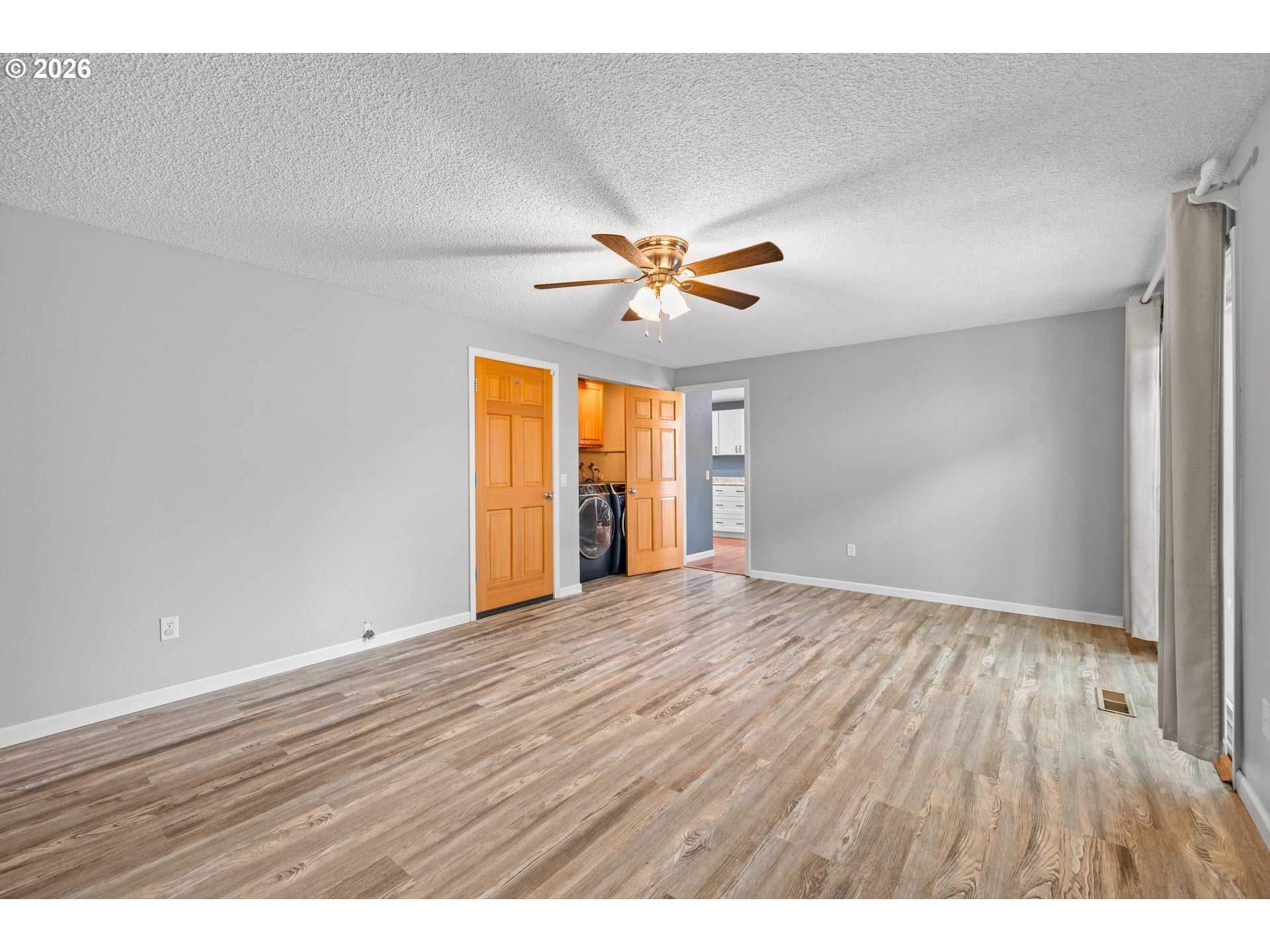 493 South Emerald Loop Cornelius, OR 97113 - Photo 22 of 46 a view of an empty room and window and wooden floor
