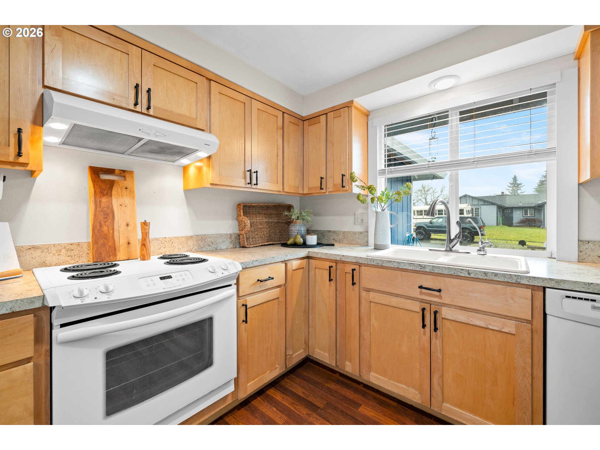 493 South Emerald Loop Cornelius, OR 97113 - Photo 5 of 46 a kitchen with stainless steel appliances granite countertop a stove a sink and a microwave