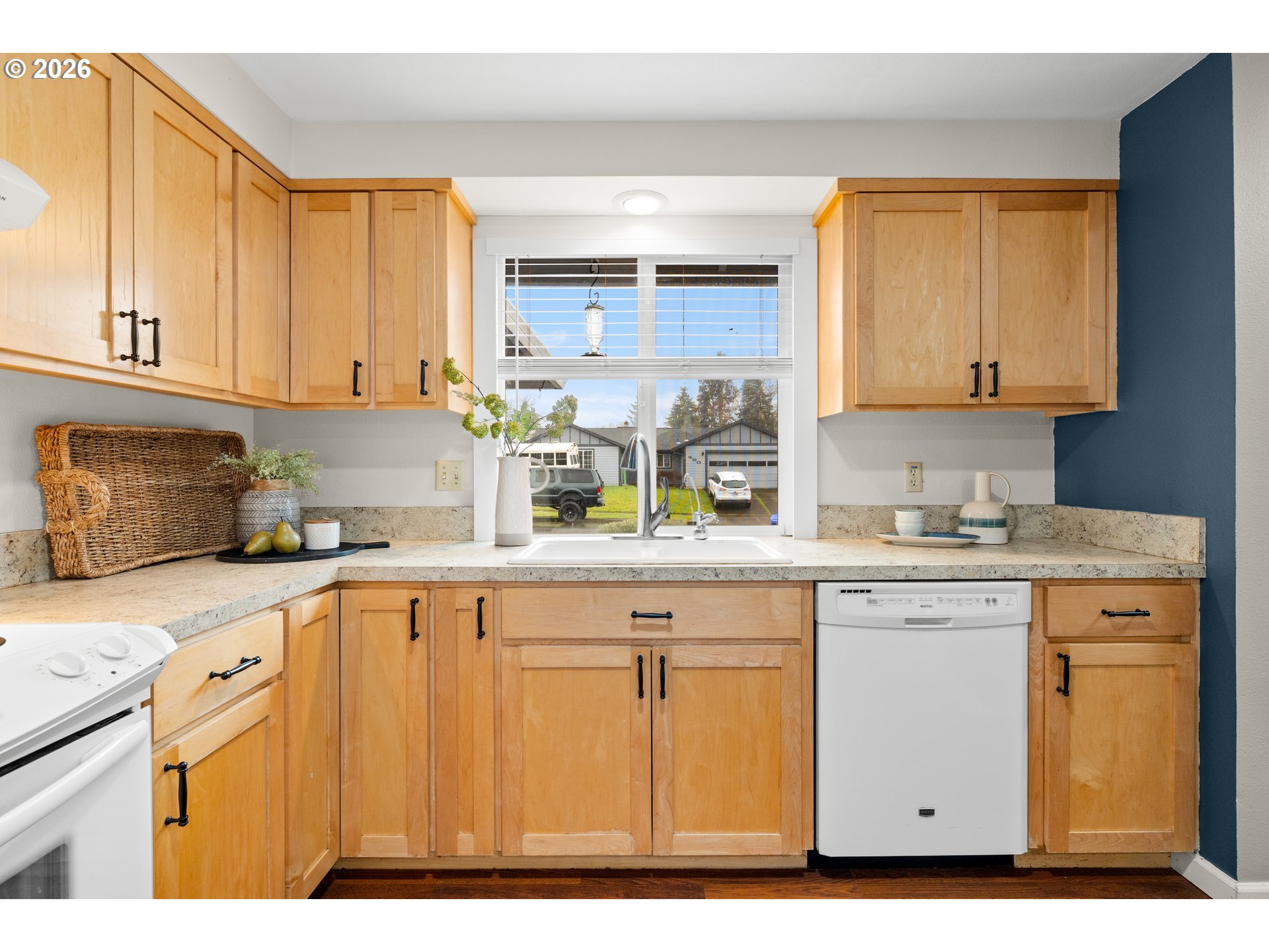493 South Emerald Loop Cornelius, OR 97113 - Photo 6 of 46 a kitchen with granite countertop a sink window and cabinets