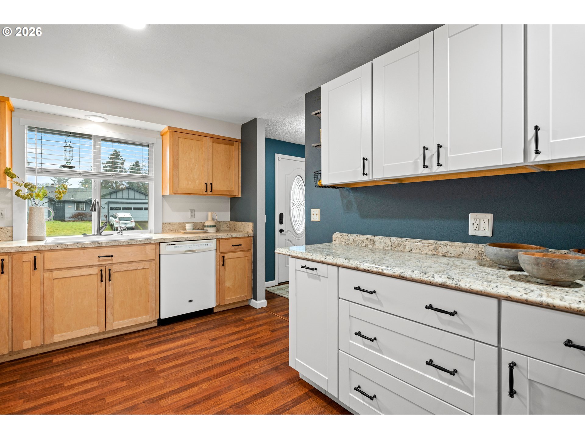 493 South Emerald Loop Cornelius, OR 97113 - Photo 7 of 46 a kitchen with granite countertop white cabinets and white appliances