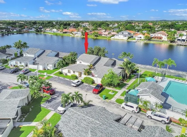 an aerial view of a house with a lake view and a large pool