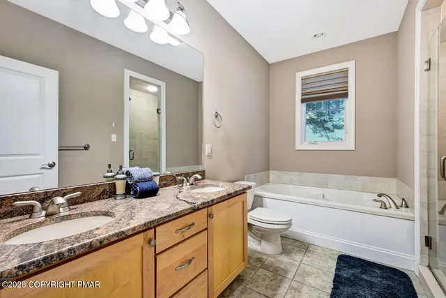 a bedroom with furniture and a air conditioner vent