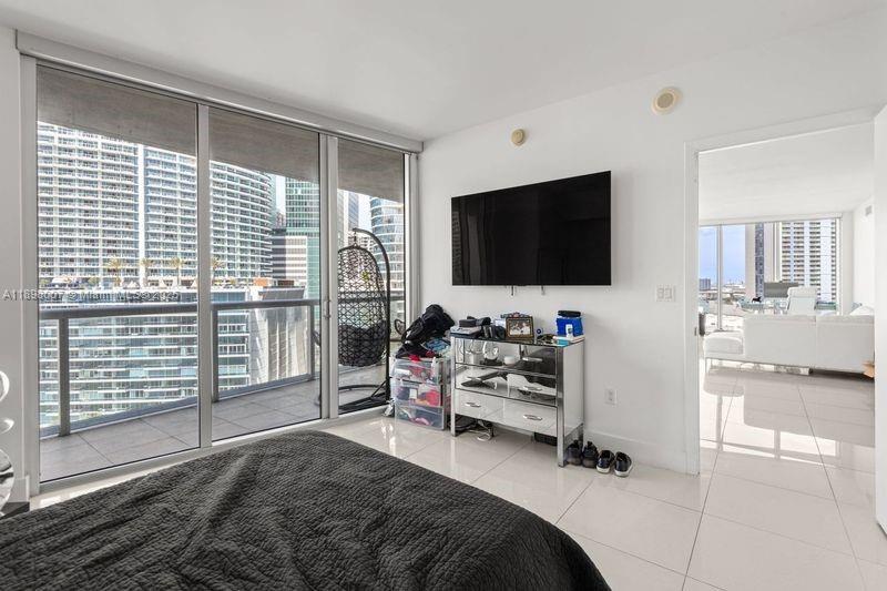 465 Brickell Avenue, Unit 1602 Miami, FL 33131 - Photo 11 of 30 a view of a livingroom with workspace and a flat screen tv