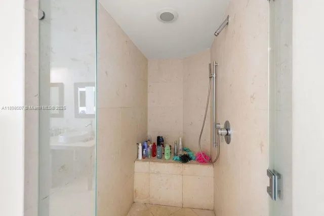 a bathroom with a shower and a sink