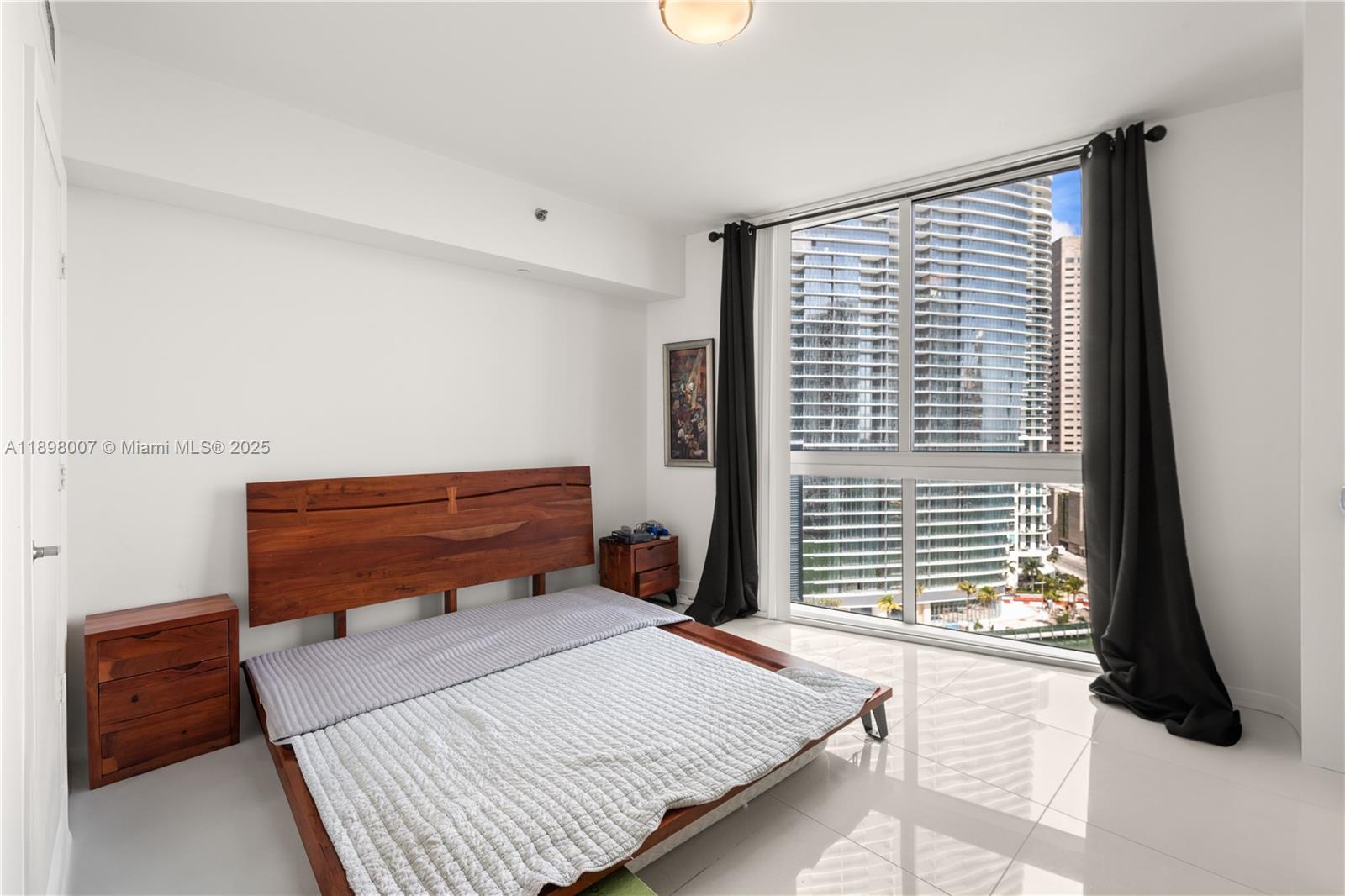 465 Brickell Avenue, Unit 1602 Miami, FL 33131 - Photo 20 of 30 a bedroom with a bed and a window