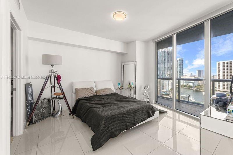 465 Brickell Avenue, Unit 1602 Miami, FL 33131 - Photo 6 of 30 a bedroom with a bed and a mirror