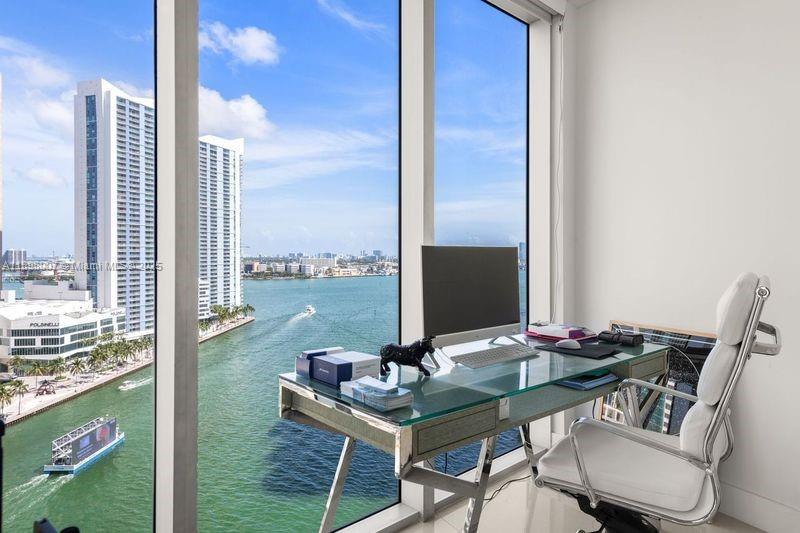 465 Brickell Avenue, Unit 1602 Miami, FL 33131 - Photo 7 of 30 a view of a balcony with table and chairs
