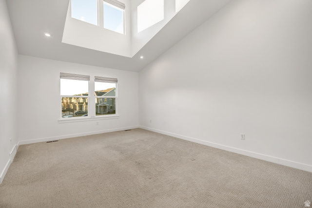 1058 Lilac Way Mapleton, UT 84664 - Photo 10 of 28 Unfurnished room with a towering ceiling, light carpet, and recessed lighting