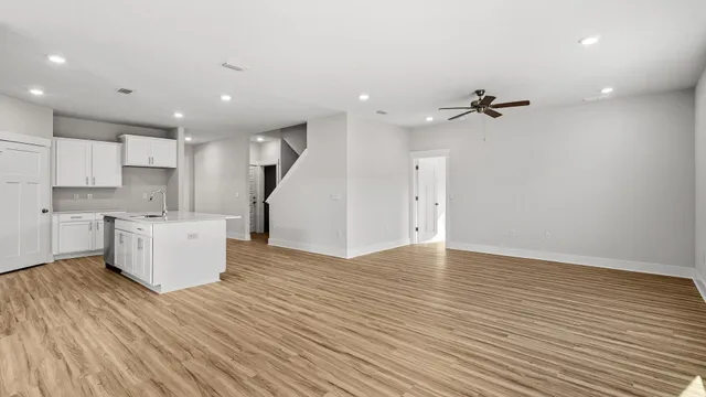 a view of an empty room with kitchen appliances and a window
