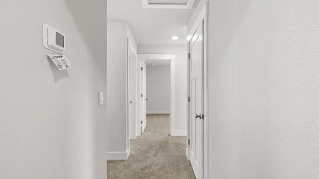 a view of a hallway with paintings on the wall