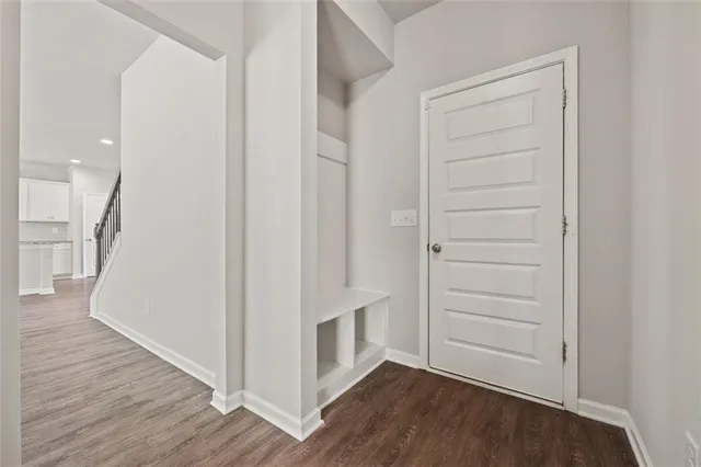 a view of walk in closet with wooden floor