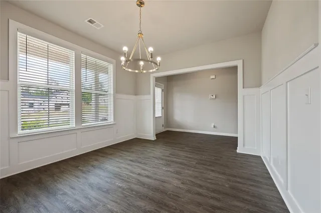 a view of livingroom with window wooden floor and chandelier