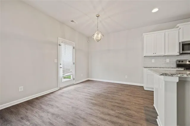 a view of a kitchen with stove and cabinets