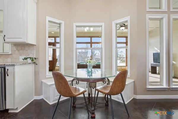 a dining room with furniture and window