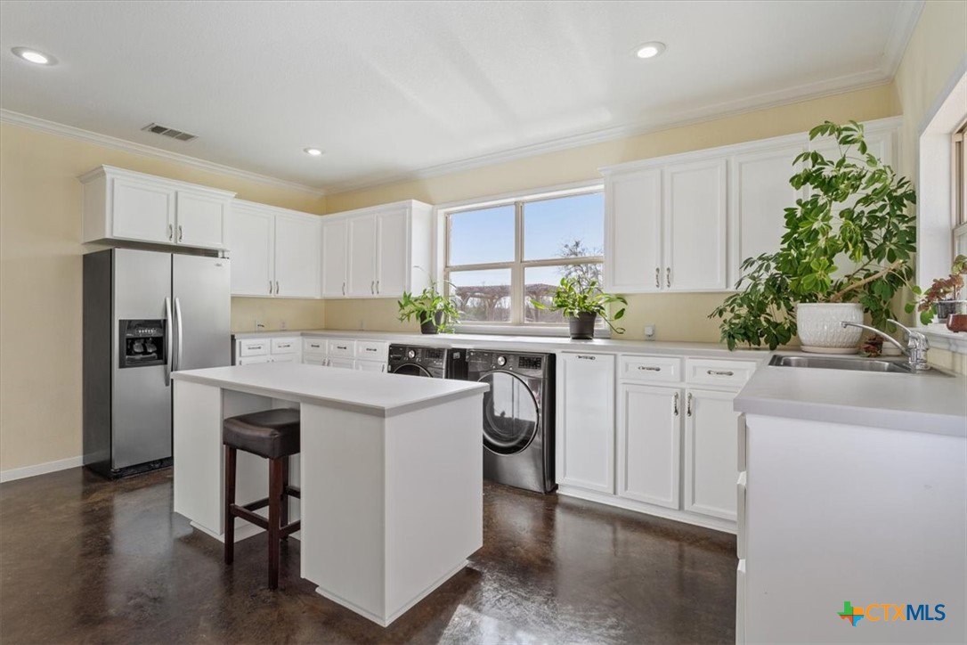 645 West Big Elm Road Troy, TX 76579 - Photo 19 of 37 a kitchen with a sink a refrigerator and a stove top oven