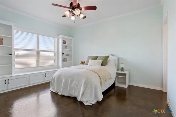 a bedroom with a large bed and a window