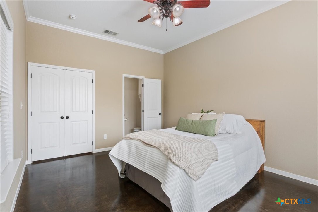645 West Big Elm Road Troy, TX 76579 - Photo 26 of 39 a bedroom with a bed and a chandelier
