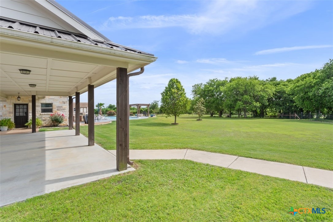 645 West Big Elm Road Troy, TX 76579 - Photo 32 of 39 a view of a house with backyard and a patio