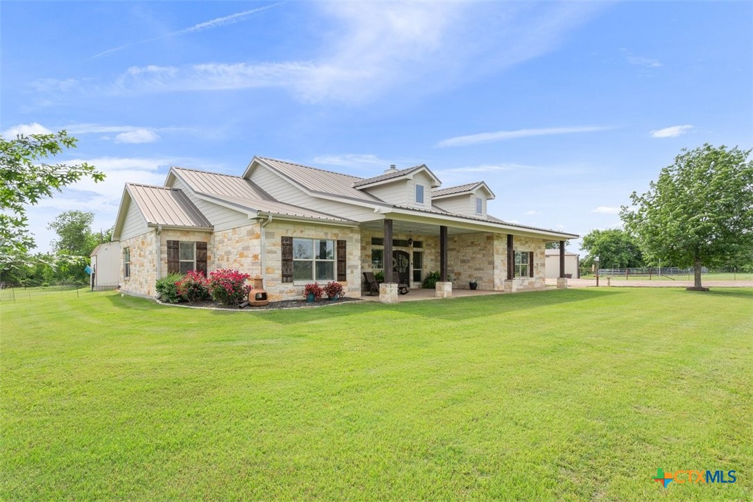 645 West Big Elm Road Troy, TX 76579 - Photo 4 of 39 a front view of a house with a garden