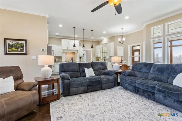 a living room with furniture and a chandelier
