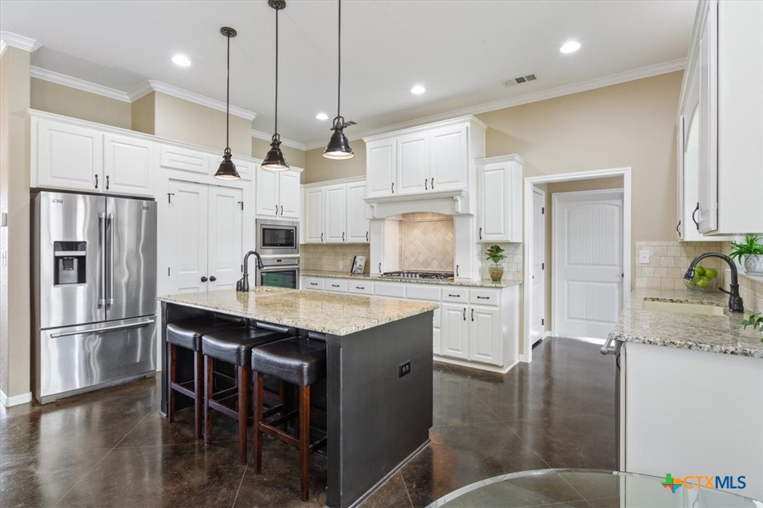 645 West Big Elm Road Troy, TX 76579 - Photo 9 of 37 a kitchen with stainless steel appliances granite countertop a refrigerator a sink dishwasher a stove and white cabinets with wooden floor