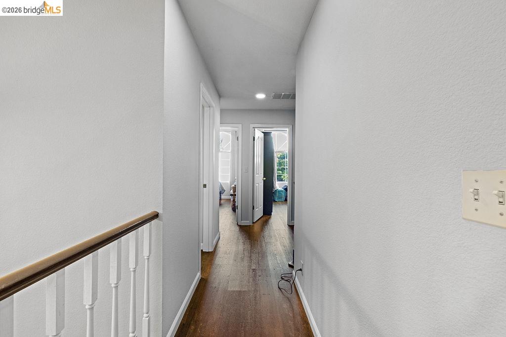 724 Winterside Circle San Ramon, CA 94583 - Photo 25 of 43 Hallway featuring wood-finish flooring and white baseboards
