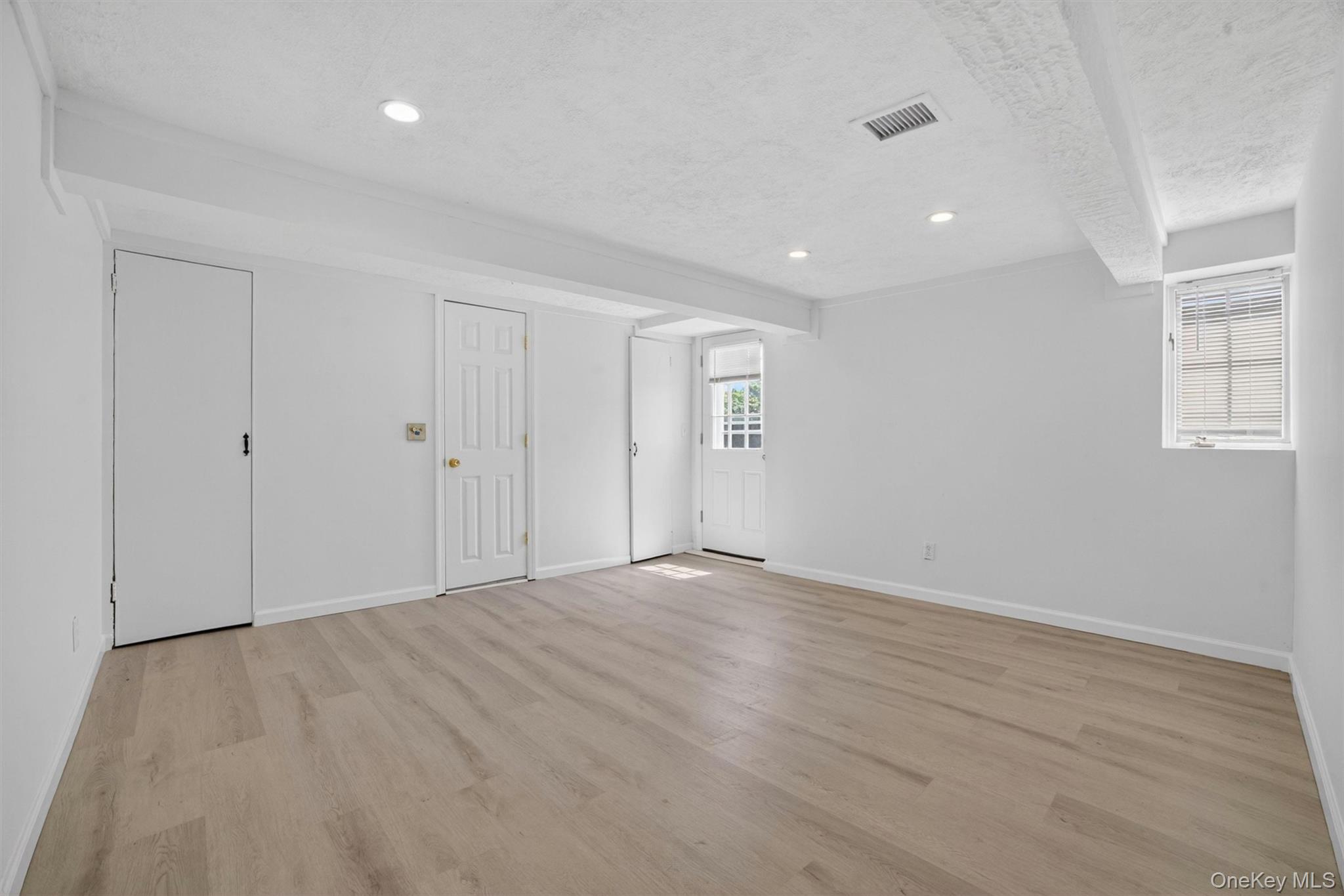 263 Croydon Road Yonkers, NY 10710 - Photo 29 of 43 a view of an empty room with wooden floor and a window