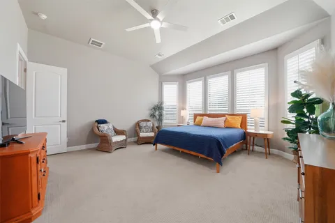 a bedroom with a bed and potted plant