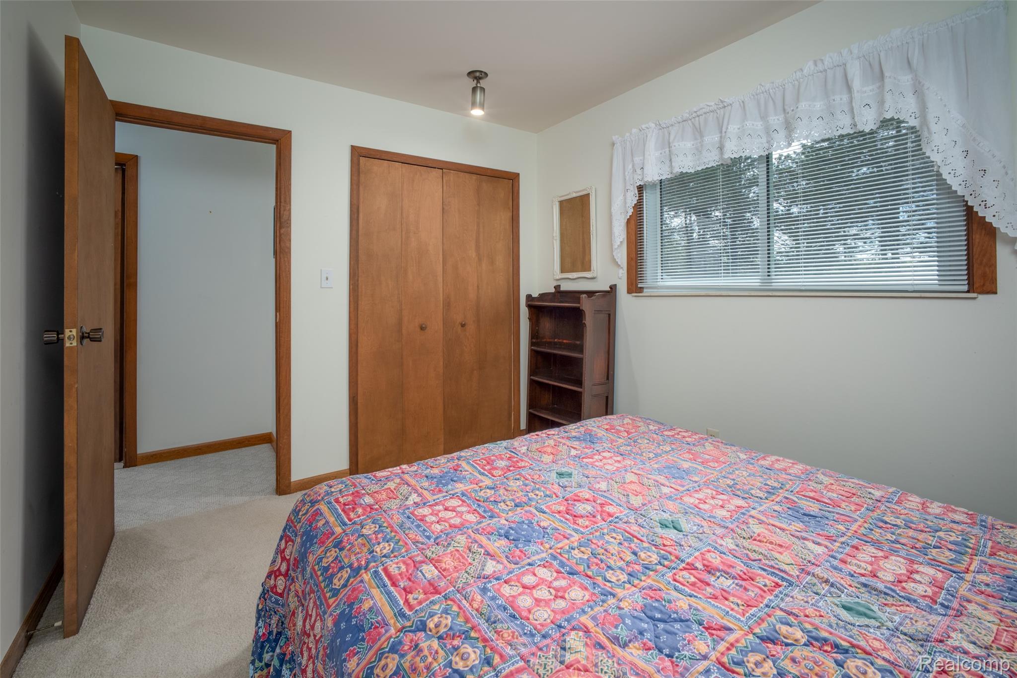 6240 Lakeshore Road Palms, MI 48465 - Photo 19 of 38 Bedroom featuring light colored carpet and a closet