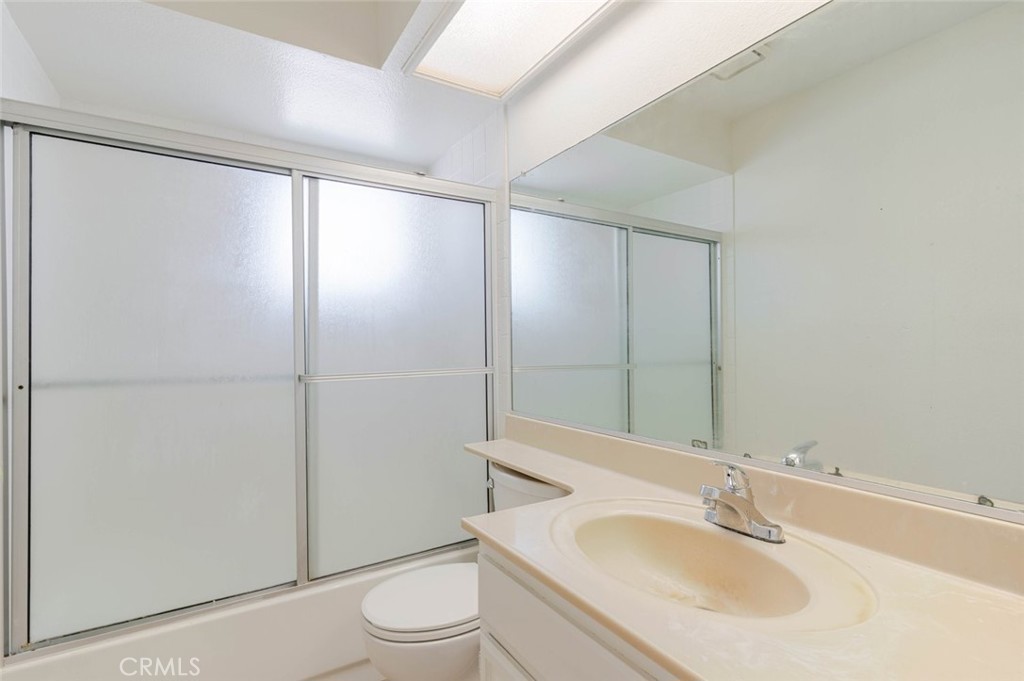 4906 Pacifica Avenue Palmdale, CA 93552 - Photo 15 of 36 a bathroom with a sink and a mirror