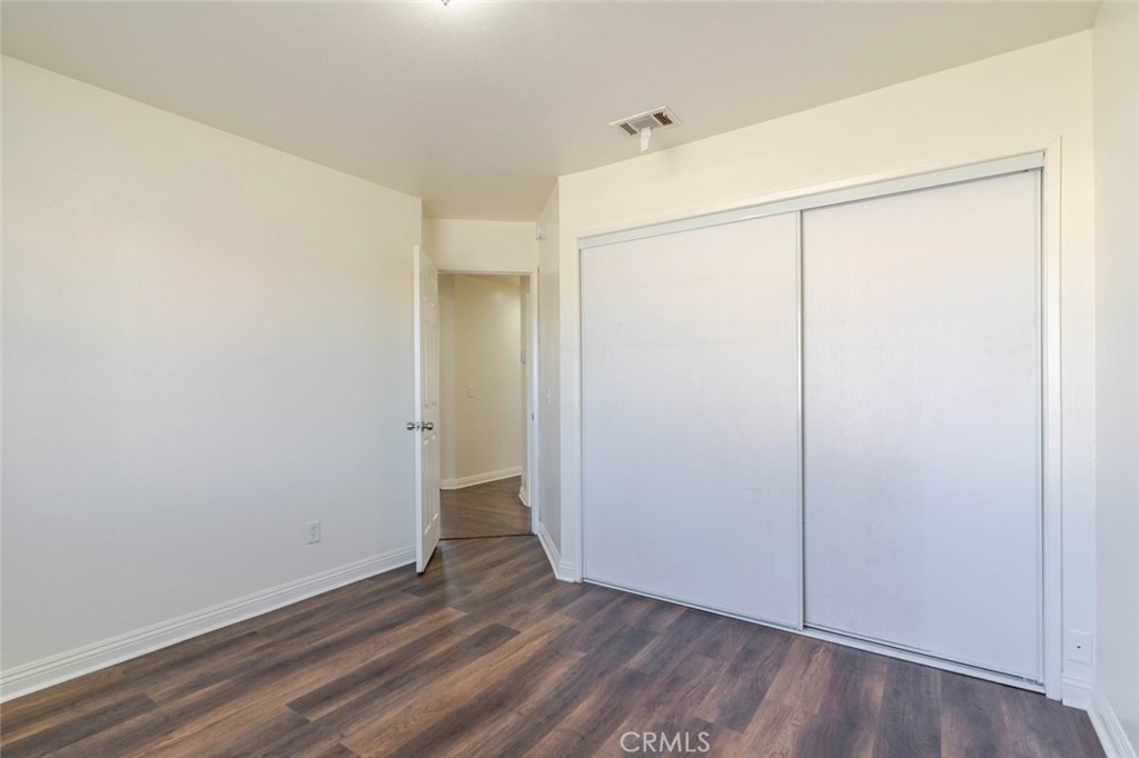 4906 Pacifica Avenue Palmdale, CA 93552 - Photo 17 of 36 an empty room with wooden floor