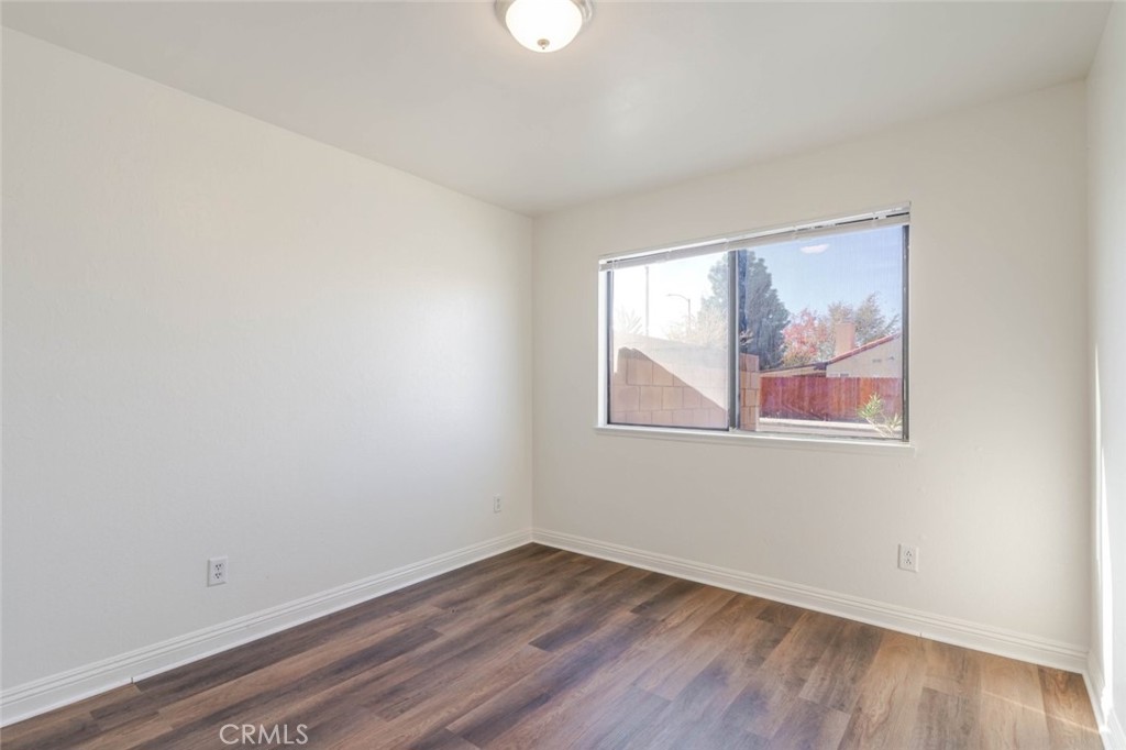 4906 Pacifica Avenue Palmdale, CA 93552 - Photo 18 of 36 wooden floor in an empty room with a window